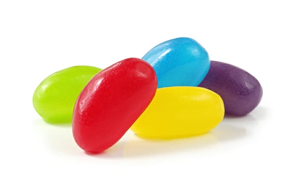 Jellybeans isolated on white, with soft natural light shadow.