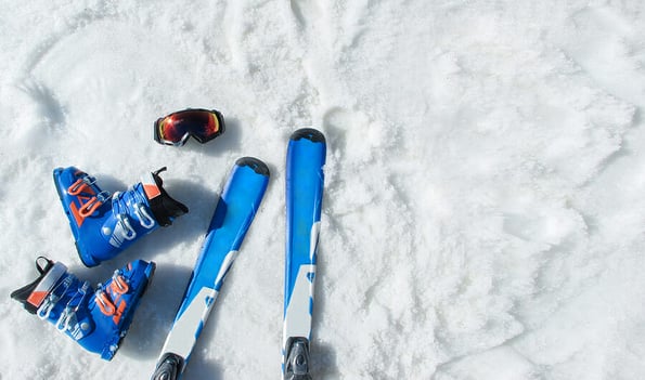 Mountain skis, sunscreen mask or ski goggles, ski boots on bright alpine snow. Winter holidays. Vacation, travel content. Copy space