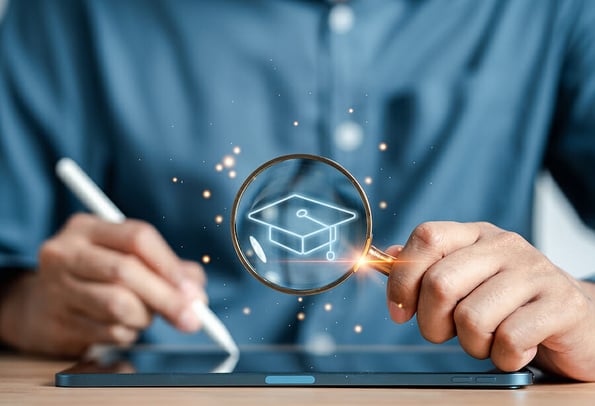 E-learning online class, magnifier focus to degree graduation cap icon, watching video on internet, webinar online, education on internet, e-learning, learning online with webinar, education concept.