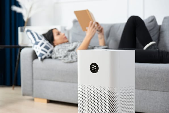 Woman using air purifier, PM 2.5 dust filter, clean and health air