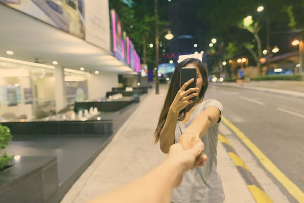 Young beautiful Asian woman wandering in the city streets at night in Kuala Lumpur, Malaysia
