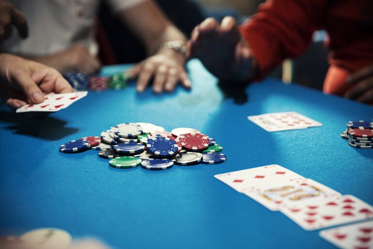 Poker players gathered around a casino table, representing the rise of interactive at-home casino nights inspired by streamers.