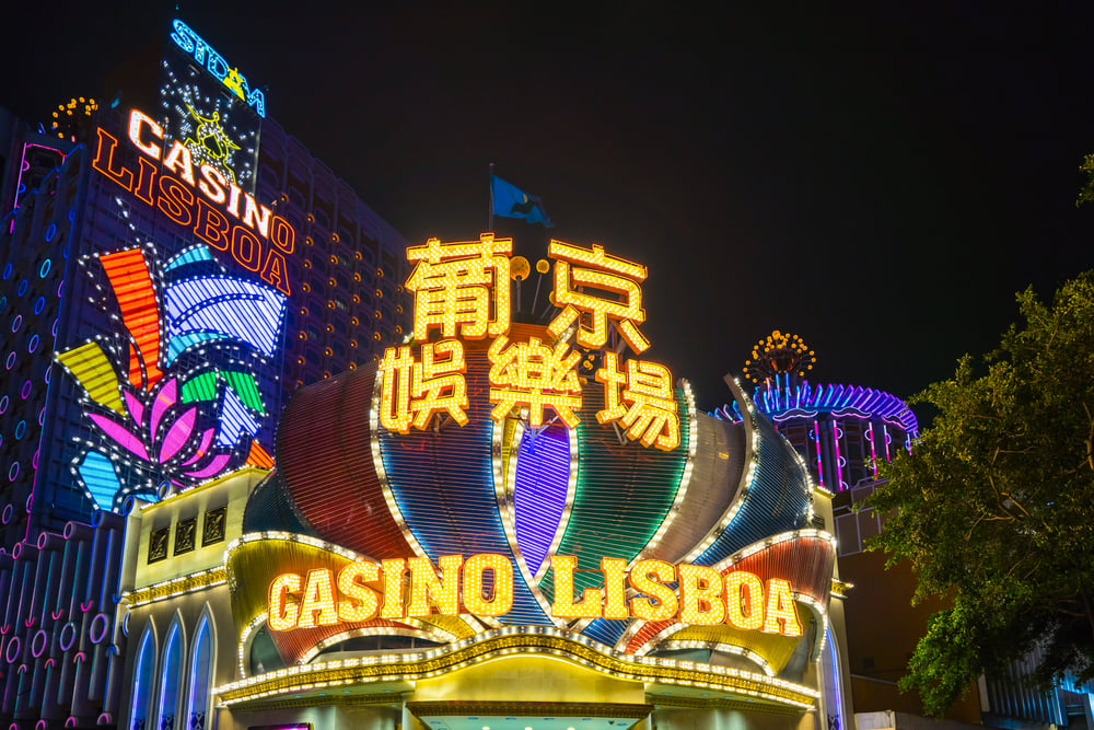 Grand Lisboa casino hotel illuminated at night in Macau