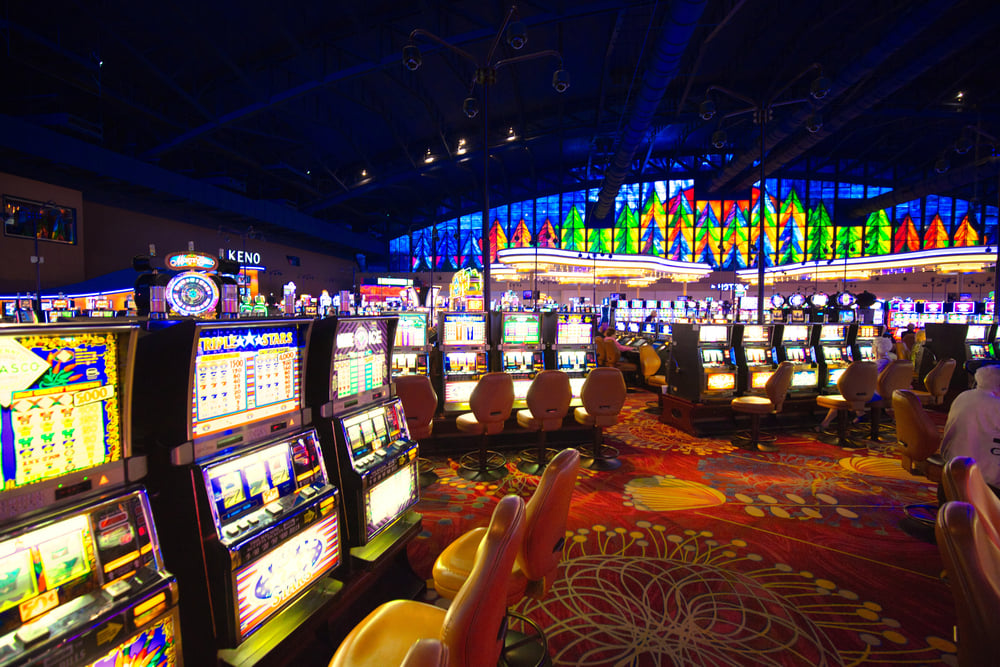 Large casino gaming floor with slots and stained glass windows