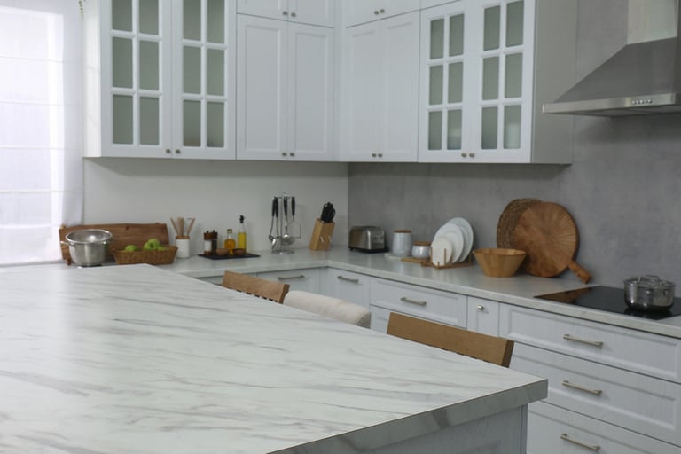 Updated Atlanta kitchen with painted cabinets, warm natural lighting, open wood shelving, modern backsplash, and budget-friendly design upgrades without a full renovation.