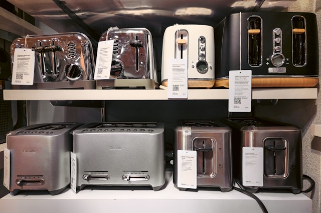 This image showcases variety of toasters in a retail store, displaying a variety of models, sizes, and designs.