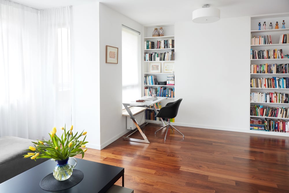 Office chair next to window seat bookcase in modern home office