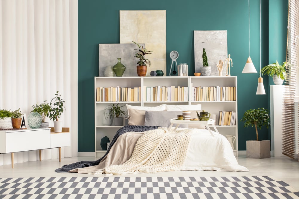 Bedroom interior with bookcase and paintings