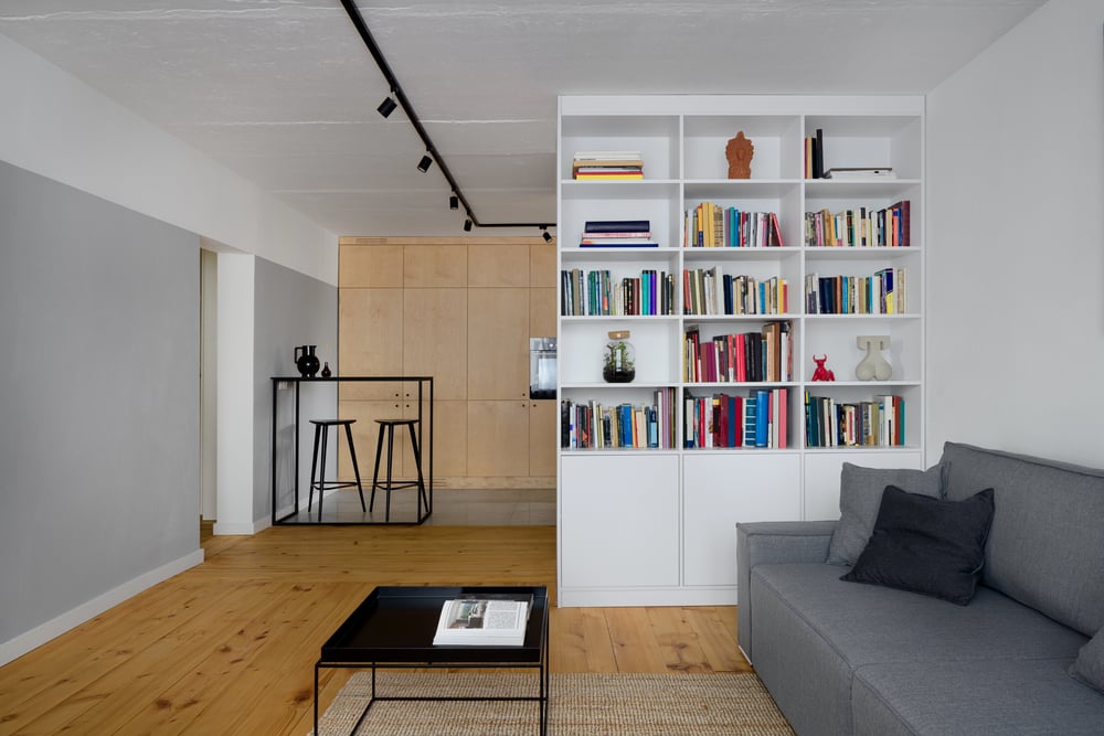 Open bookcase used as a room divider in a modern interior