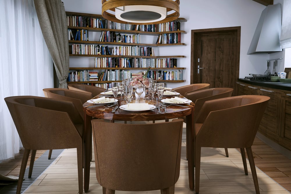 Large wooden wall bookcase beside a dining area