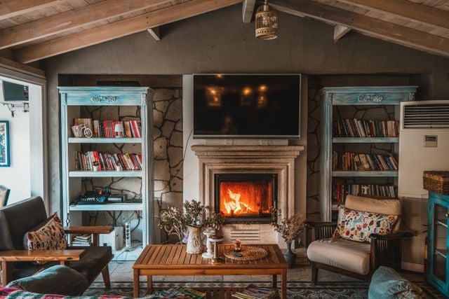 Living room fireplace framed by decorative bookshelves