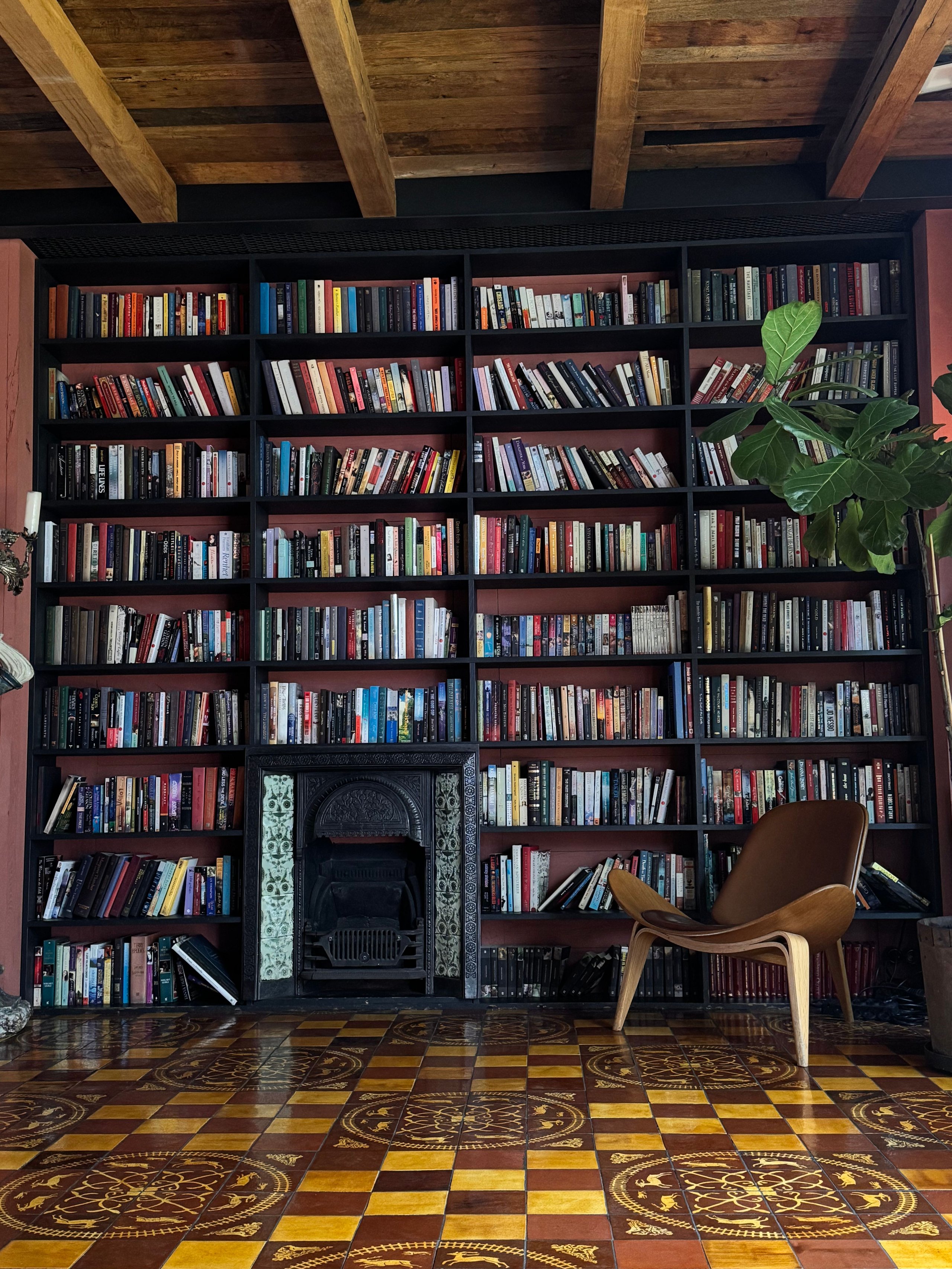 Wall-to-wall bookcase filled with books in a bright living space