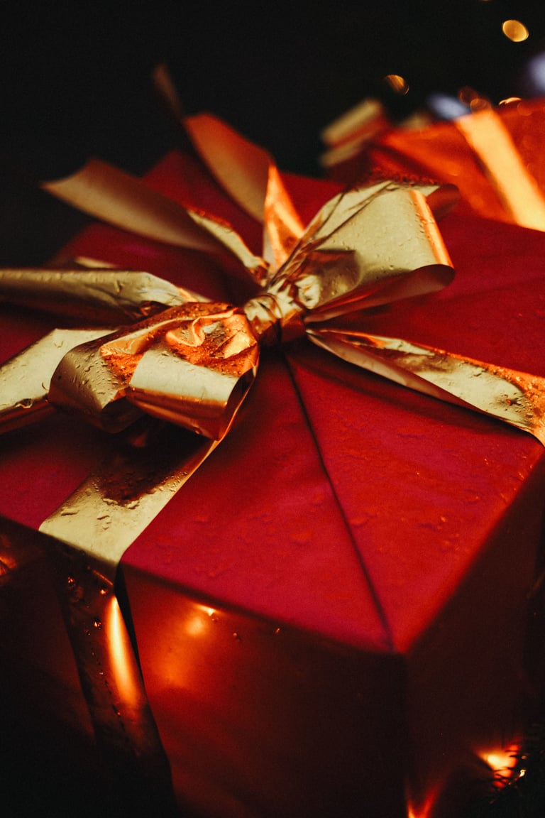 A red gift box with gold ribbon