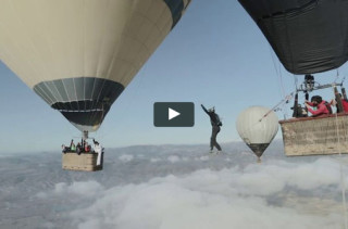 Guys Walk Tightrope Between Hot Air Balloons
