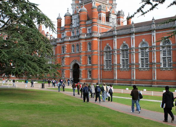 students walking to red-bricked old university building