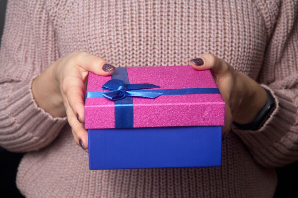 Women hands holding gift box with flowers. Gift present. Close up of hands holding gift box. Present. Birthday gift box. Christmas gift box. Hands holding gift box. Christmas birthday valentine celebration present romantic concept