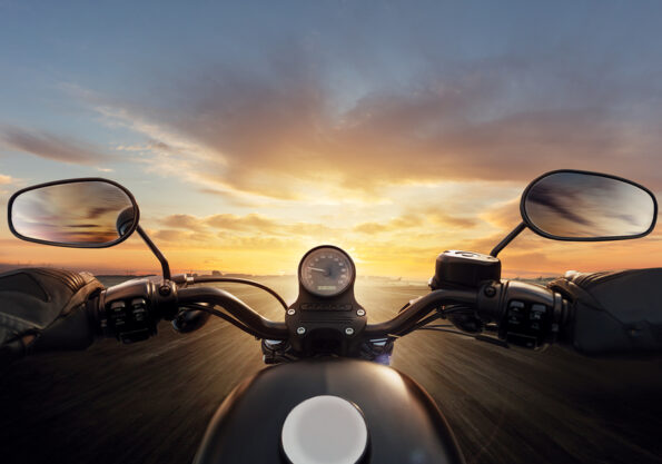 POV of motorcycle driver with handlebars. Outdoor photography. Travel and sport, speed and freedom concept