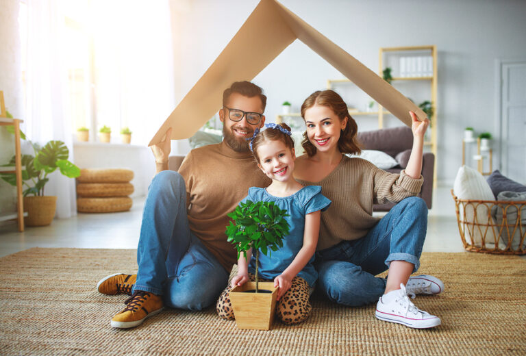concept housing a young family. Mother father and child in new house with a roof at a home