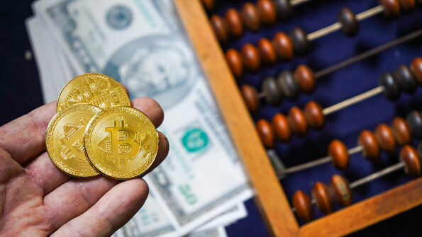 bitcoin Bitcoins on the background of dollars. Golden Bitcoins. Symbolic coins of bitcoin on banknotes . Exchange bitcoin cash for a dollar. Bitcoins and classic abacus and symbol of new and old financial tool . Abacus used for counting, adding, and subtracting