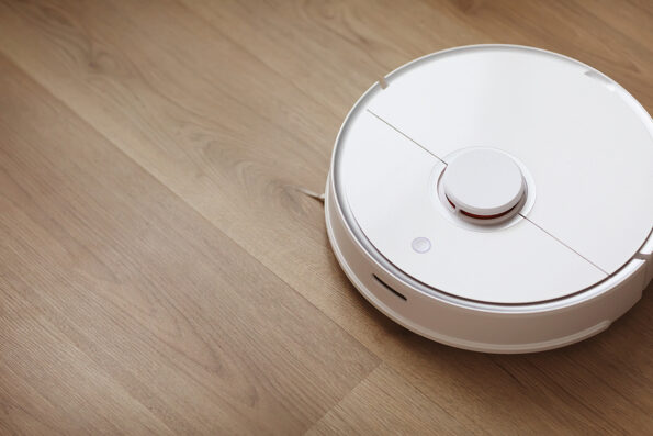 Robot vacuum cleaner performs automatic cleaning of the apartment at a certain time. white robot vacuum cleaner. home cleaning. Smart home. selective focus