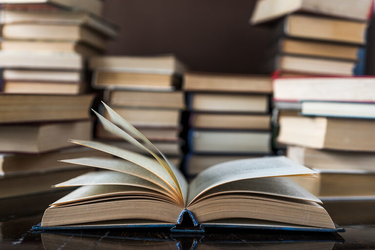 Stack of books background. a lot of books. A stack of books of different thicknesses in the library, a pile of old books, back to school reading books