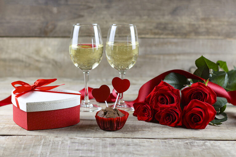 Valentine's Day concept Valentine's Day. Red rose with petals on a white background. Valentine's card, valentine's day, banners, postcard. Gift, roses and ribbon. Copyspace