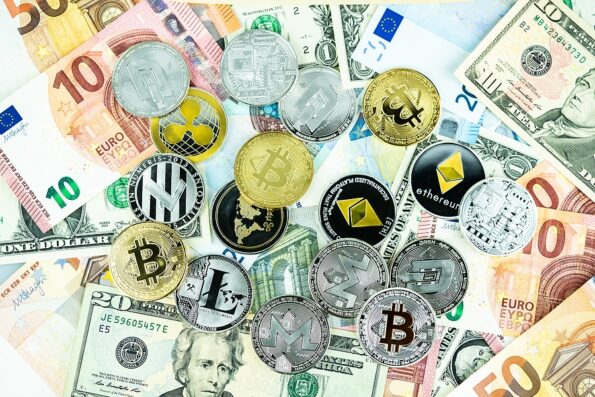 Various cryptocurrency coins on paper dollars and euros. Bitcoin, ethereum, litecoin and others modern virtual currency. Digital crypto. Metal cryptocurrency crypto currency coins