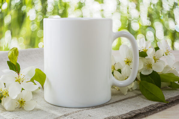 Mug mockup with spring apple blossom. Mug mockup. Coffee cup template. Coffee mug template. Mug template. Mug design template. Mug design. Mug printing design. White mug mockup. Cup mockup. Blank mug.
