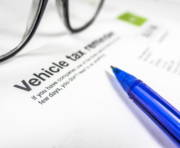 Detail of A Vehicle Tax Reminder Letter Or Form With Glasses And Pen On A Desk With Copy Space