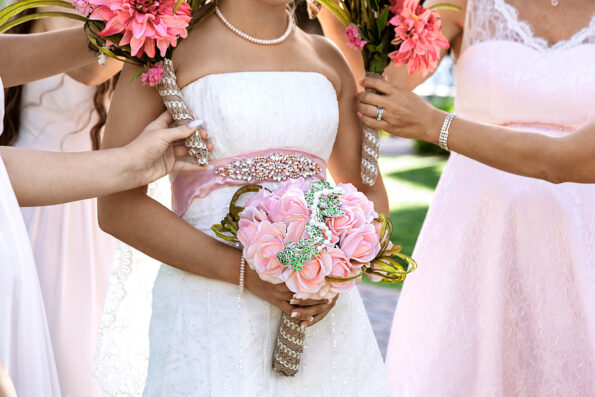 Bride and bridemaids are holding bouquets of flowers in hands on a wedding day - Image