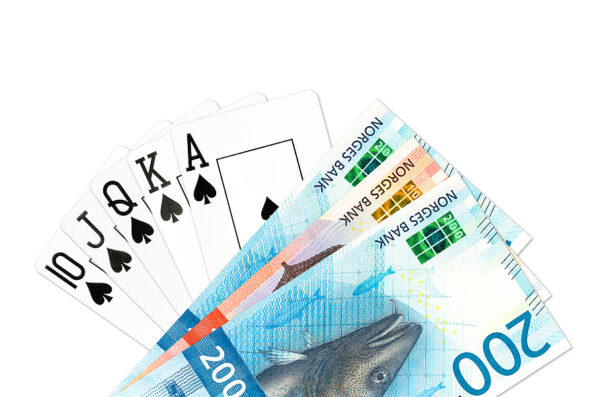 poker hand royal flush in spades and some norwegian krone bank notes isolated on white background