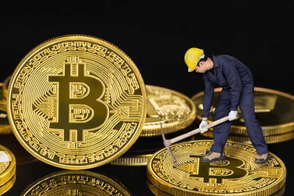 Bitcoin cryptocurrency digital bit coin BTC currency concept ,Bitcoin mining worker holding mattock digging golden Bitcoin crypto currency coin on a black background