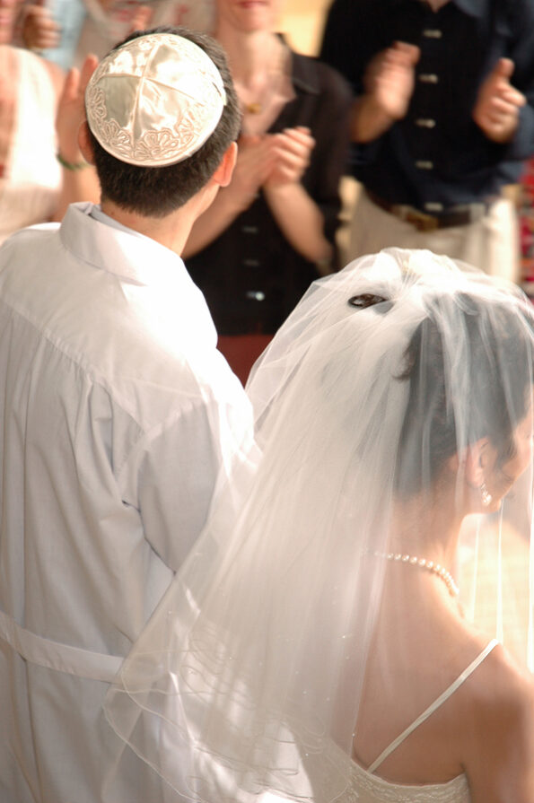 Jewish couple leaving their wedding ceremony.