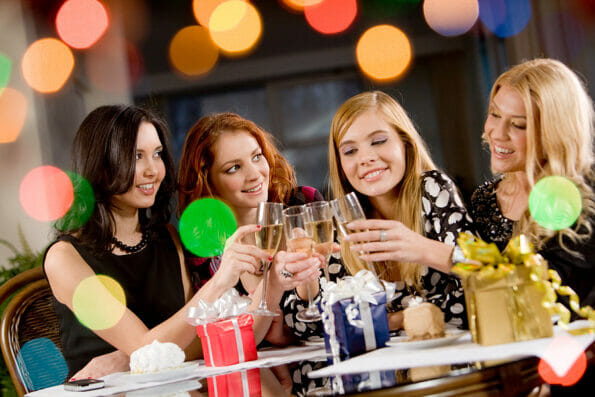 Portrait of attractive women clinking champagnes with each other during hen-party