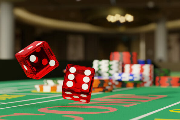 Close up of a pair of dice rolling down a craps table. Selective focus.Gambling concept. 3d illustration.