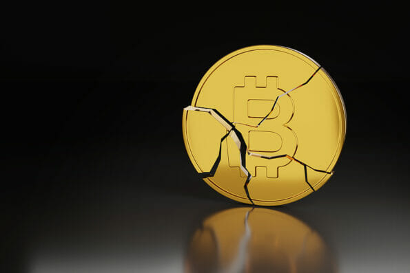 Broken Bitcoin on dark background with copy space. Cryptocurrency crash concept. 3d illustration.