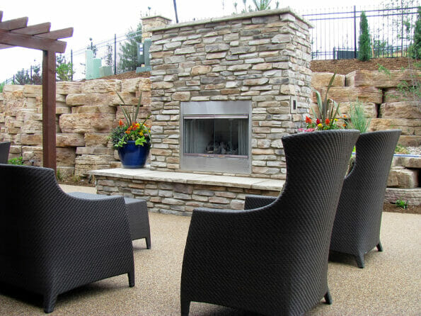 An outdoor fireplace on the back patio with chairs great for entertaining and relaxation