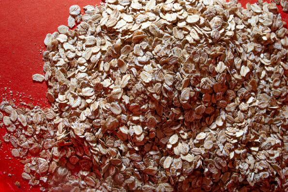 macro photography on the background of oatmeal. oatmeal close-up on a red background.
