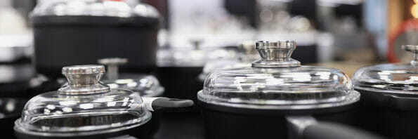 Set of pots and pans in store. Selection of quality utensils for cooking concept