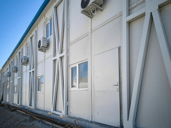 Two-storey modular industrial building. Newly built prefabricated building. Prefabricated office container building at construction site