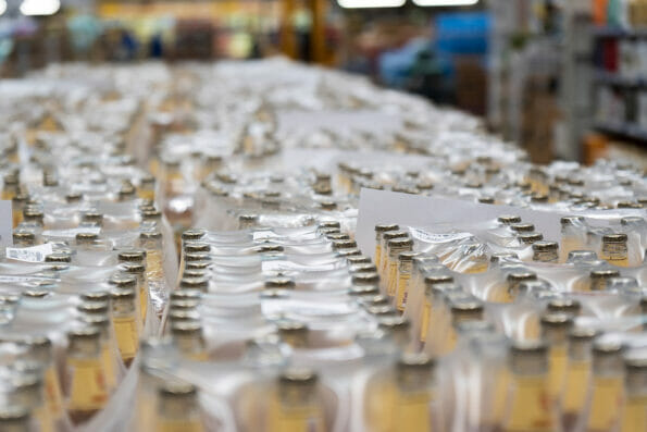 A lot of beer bottles, wholesale alcohol in a hypermarket. Selective focus
