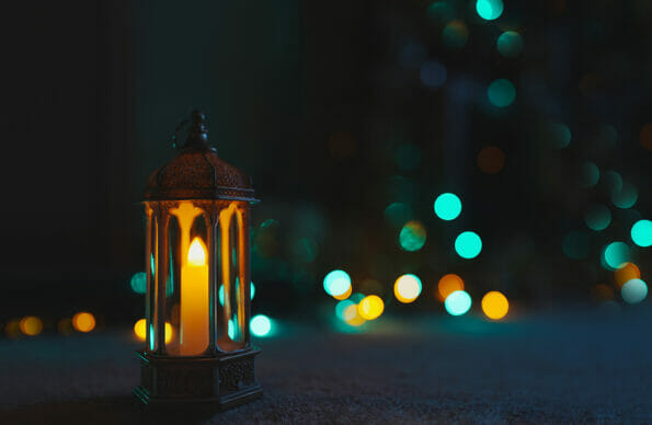 Arabic Lantern on black marble with blurry bokeh light background.Eid decorative traditional lamps illuminated ready for the Holy season of Ramadan Kareem.Concept for Islamic muslim holidays celebrate