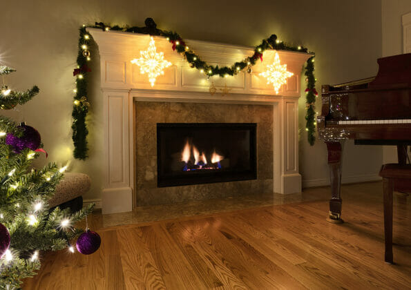 Natural gas insert heat fireplace glowing during the Christmas or New Year holiday in home living room