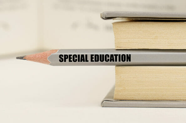 Education concept. In the book between the pages lies a pencil with the inscription - Special education