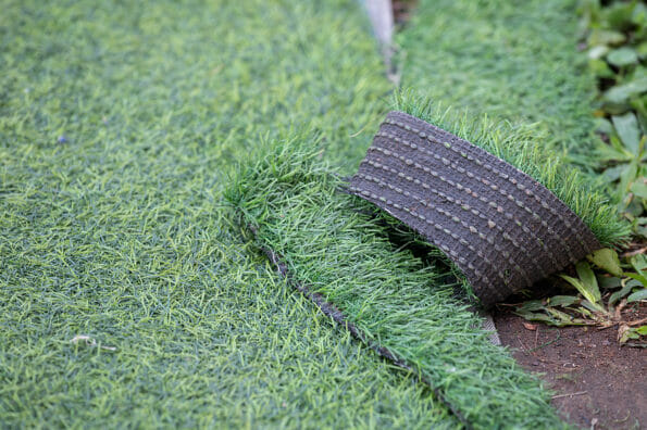 Green artificial turf used for covering sport arena or garden. Artificial grass are made by polyethylene or nylon, convenient and it does not require much maintenance.
