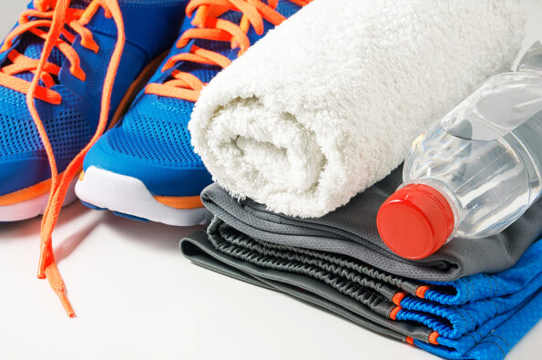 Fitness gym accessories with sport clothing towel drinking water and running shoes