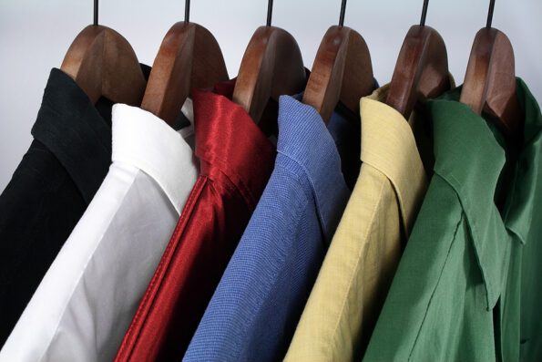 Man's wear: choice of colorful shirts on wooden hangers.