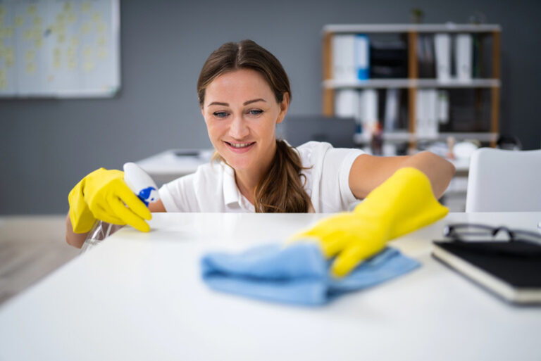 Professional cleaners working in a business environment, showing the importance of workplace cleanliness and maintenance.